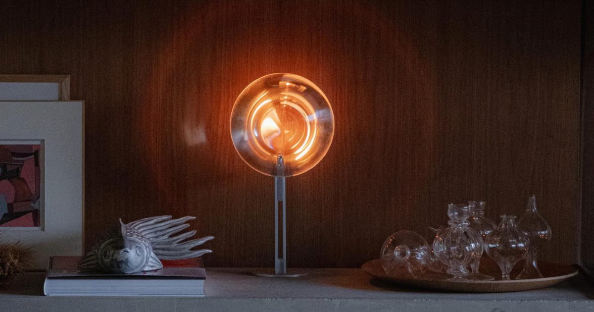 Round glass candle-powered lamp